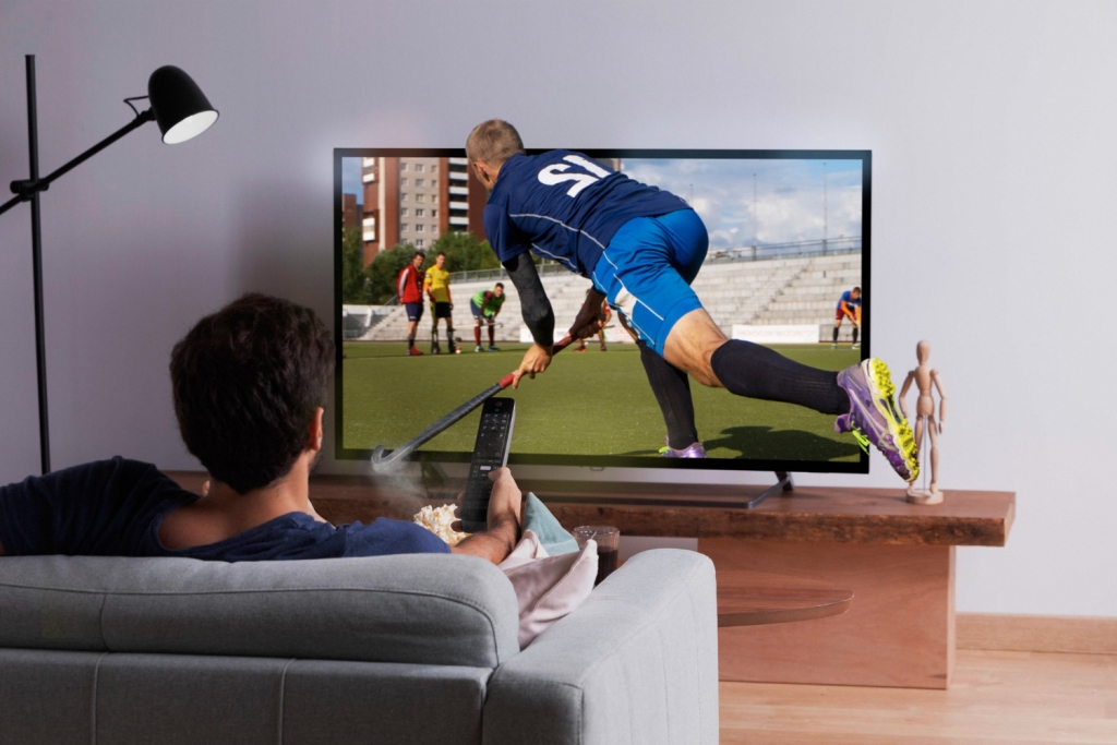 homem assistindo esportes em um dos planos blue tv